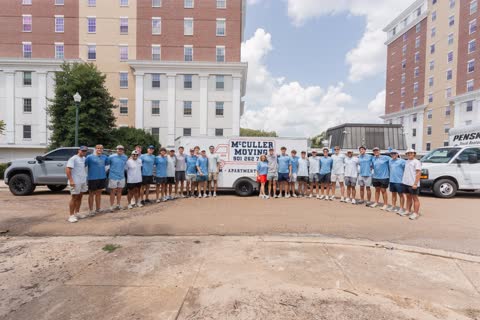 The whole crew gathered around the McCuller Moving trailer outside the Ole Miss residence halls