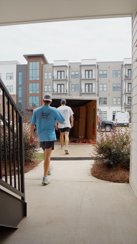 Crew members heading back to the open trailer outside a student apartment complex in Oxford