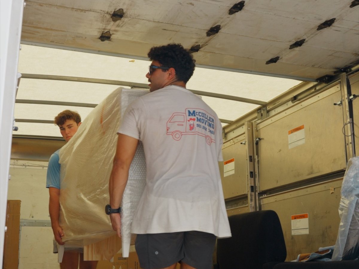 McCuller Moving crew loading wrapped furniture into a packed moving truck